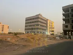 A residential/commercial plot of land in Al Alia, Ajman, measuring 4300 sq ft, with a building permi