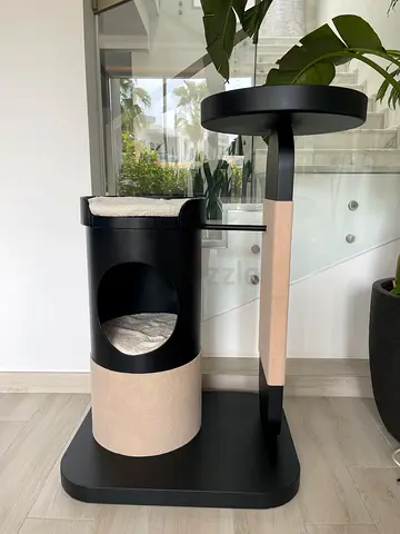Compact black cat tree with scratching posts and hideaway bed