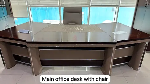 Large executive office desk with high-back chair