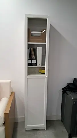 Slim white tall storage cabinet with shelves and door