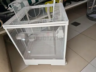 White bird cage with tire to push