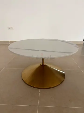 Round white marble-top coffee and side table with gold pedestal base