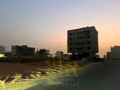\A residential/commercial plot of land in Al Alia, Ajman, measuring 4306 sq ft, with a building per