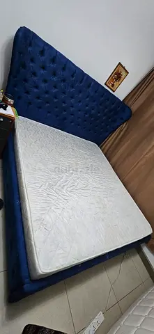 Blue tufted fabric king-size bed frame with mattress included