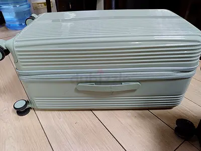 Light green hard-shell carry-on roller suitcase, good condition