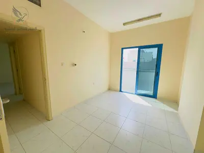 Two rooms and a living room with a balcony, central air conditioning in Al Hamidiya