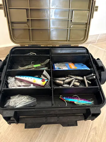 Fishing tackle box with assorted lures and sinkers