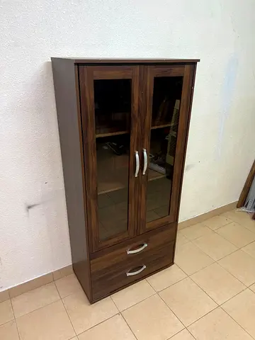 Tall wooden cabinet with glass doors and two drawers - good condition