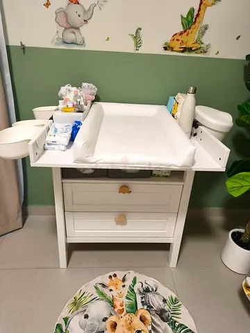 White baby changing table with drawers and accessories