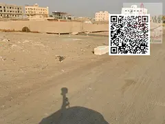 Two adjacent plots of land for sale in Masfout, very prime location, price negotiable