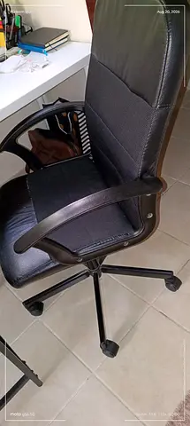 Used black high-back office swivel chair with armrests