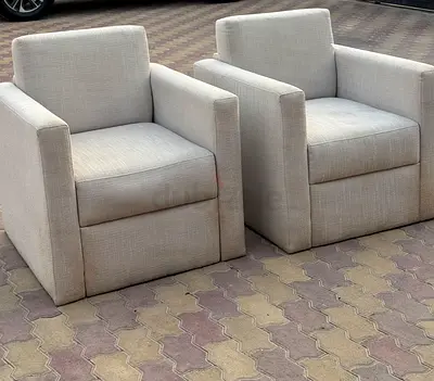 Pair of light grey upholstered armchairs — modern club chairs