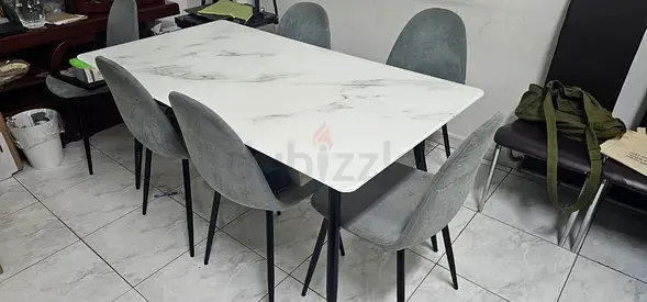 modern 6-seat dining table set with a white marble-effect rectangular tabletop