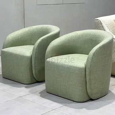 Pair of light green modern curved lounge chairs