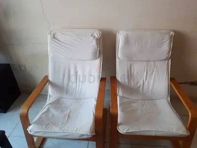 Pair of IKEA PELLO wooden frame lounge chairs with white cushions