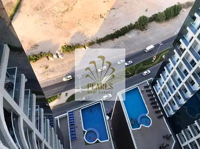 Furnished 1BR for annual rent in Oasis Tower with balcony and parking, offering a comfortable layout in a prime Ajman location