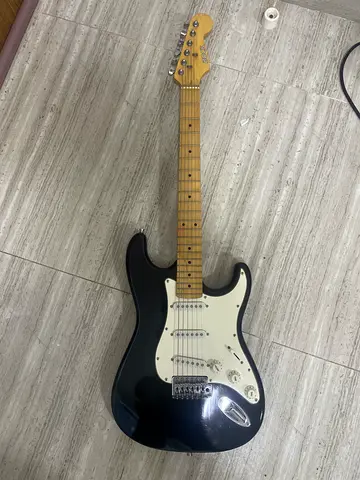 Used black S-style electric guitar with maple neck - plays well