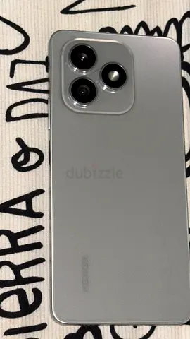 Used silver smartphone with triple rear cameras - good condition