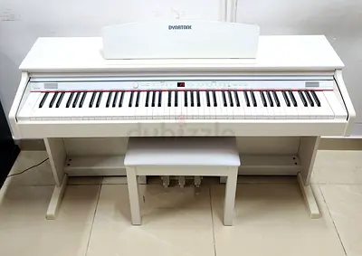 The Dynatone SLP-150 in white is a slim, space-saving digital piano featuring an 88-key weighted New