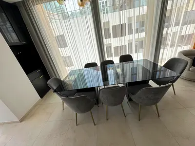 Cantoni Italian Modern black glass-top dining table with marble pedestal bases