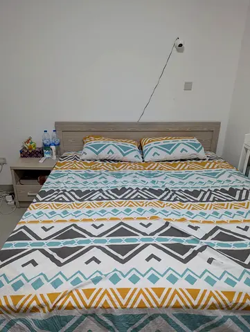 Queen bed frame with mattress and matching bedside tables - good condition