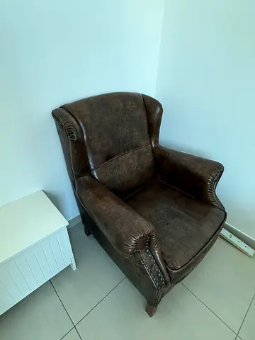 Brown artificial leather-look single armchair with wooden legs
