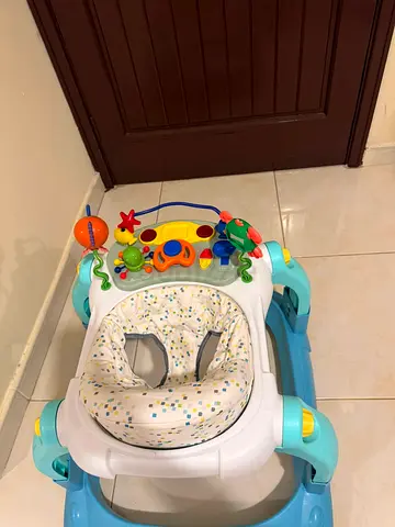 Baby walker with activity tray — good condition.