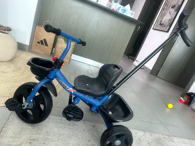 Blue toddler tricycle with parent push handle and storage buckets - move out Dubai sale