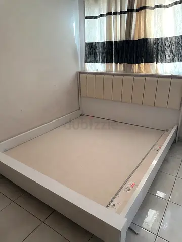 White wooden double bed frame with padded headboard - good condition