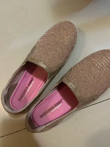 Gold slip-on women's sparkling loafers, size not specified
