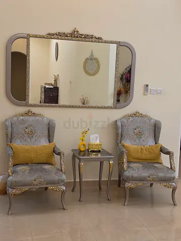 Pair of classic upholstered armchairs with matching side tables and mirror and matching dresser.