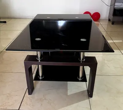 Modern glass top coffee table with dark wood base