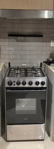 Midea stainless steel 4-burner gas cooker with oven - good condition