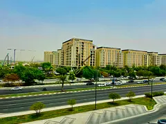 Luxury light brand new one bedroom with balcony with wardrobe in front of Almamasha community