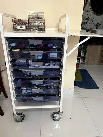 Multi purpose storage with wheels and foldable side board