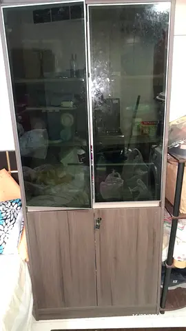 Tall storage cabinet with glass doors and lower wooden cupboards - used