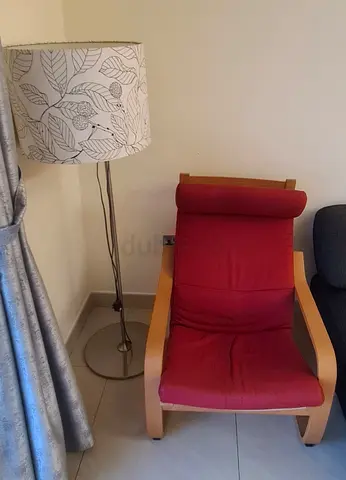 Ikea Poäng armchair with red cushion and wooden frame