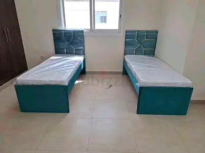 Pair of single beds with storage and upholstered headboards - teal