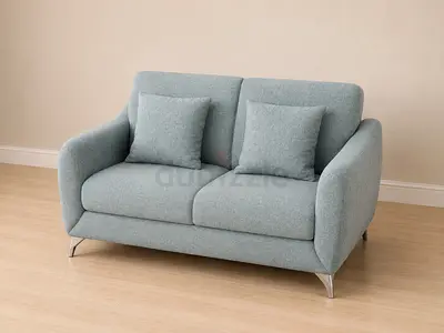 Comfortable light blue 2 seater sofa with pillows