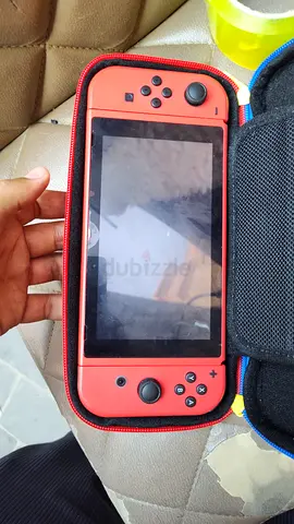 Nintendo Switch console with red Joy-Con and carry case - used