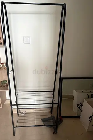 Simple black metal freestanding clothes rack with shoe shelves