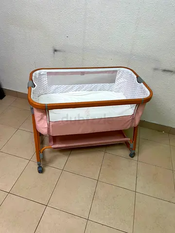 Light Pink Bedside Bassinet with Wheels and Storage Shelf