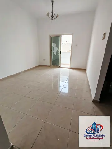 The cheapest one-bedroom apartment in Al Qasimia Al Mahatta, next to Al Mahatta Park, featuring a kitchen, two bathrooms, and a balcon .