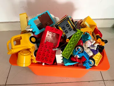 Box of DUPLO including vehicles and superhero figurines