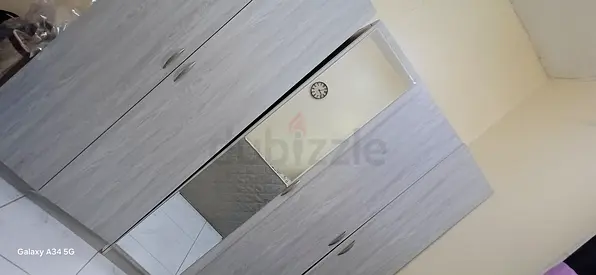 3-door mirrored wardrobe in light wood finish - good condition