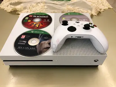White Xbox One S console with controller and 3 games
