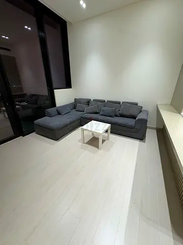 L-shaped dark grey fabric sofa with chaise