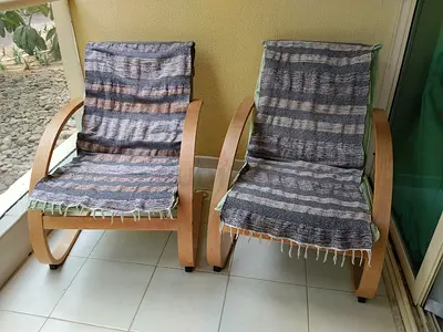 Pair of wooden lounge chairs with removable woven covers