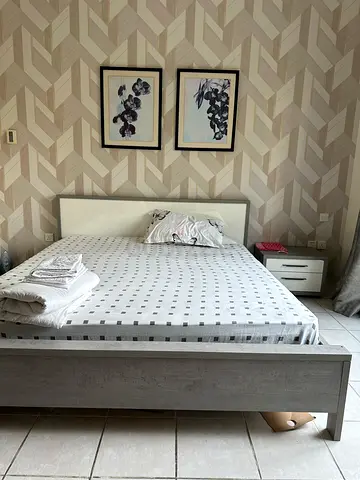 King size bed frame with mattress along with 2 side tables in excellent condition.