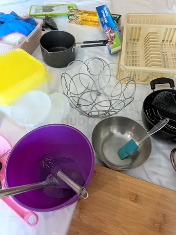 Mixed kitchen utensils and baking accessories - bowls, whisk, pots, racks (used)